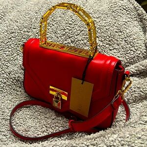 Brand new Steve Madden clutch. Red and gold.